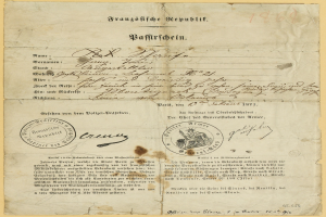 Altes deutsches Regierungsdokument mit einem kreisförmigen, schwarz umrandeten Stempel auf vergilbtem Papier, geschrieben in schwarzer Tinte.