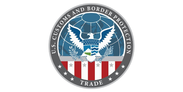Blauer Kreis mit einem weißen Rand, der eine weiße Taube mit ausgebreiteten Flügeln, einen weißen Stern in der Mitte und den Text "U.S." über der Taube enthält.